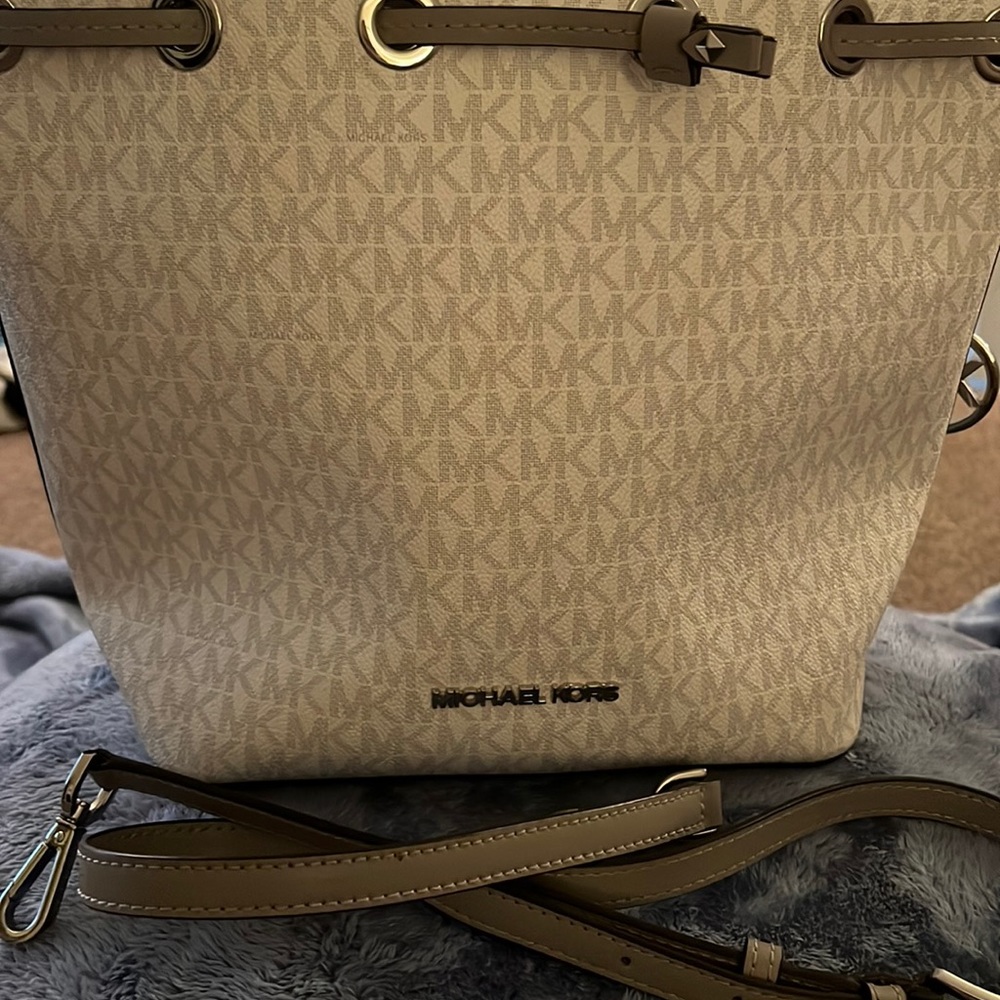 Michael Kors bucket handbag.  With strap silver and white